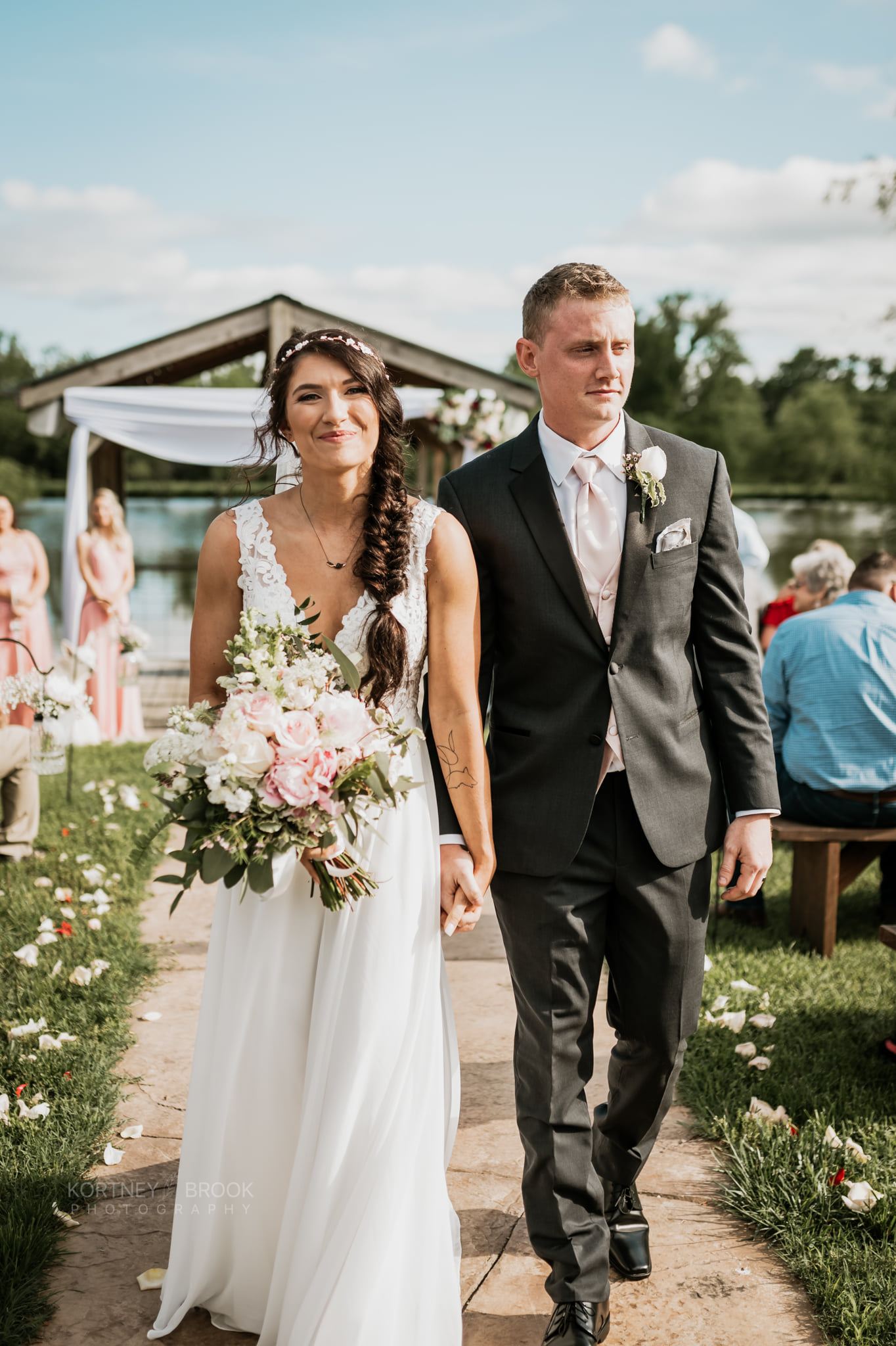 Bride walks with groom after ceremony at the dock