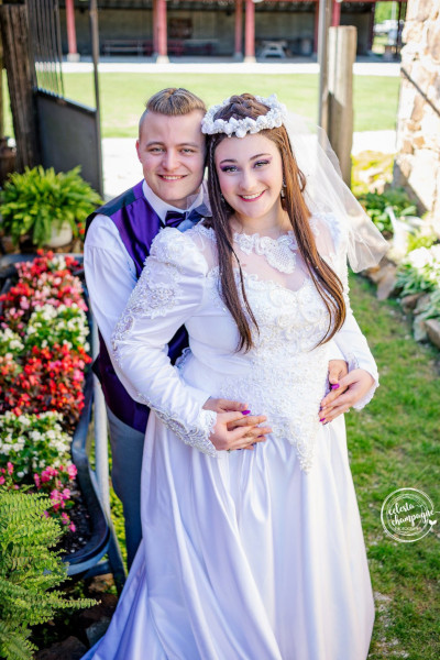 Bride and Groom in front of flowers at Civil War Ranch