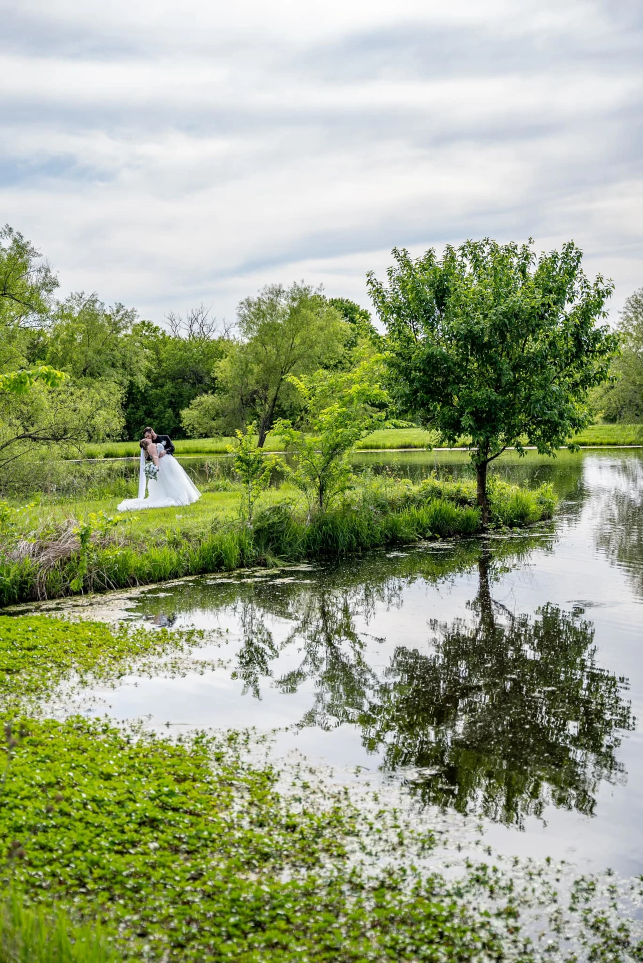 Bride and groom kiss on the peninsula at Civil War Ranch