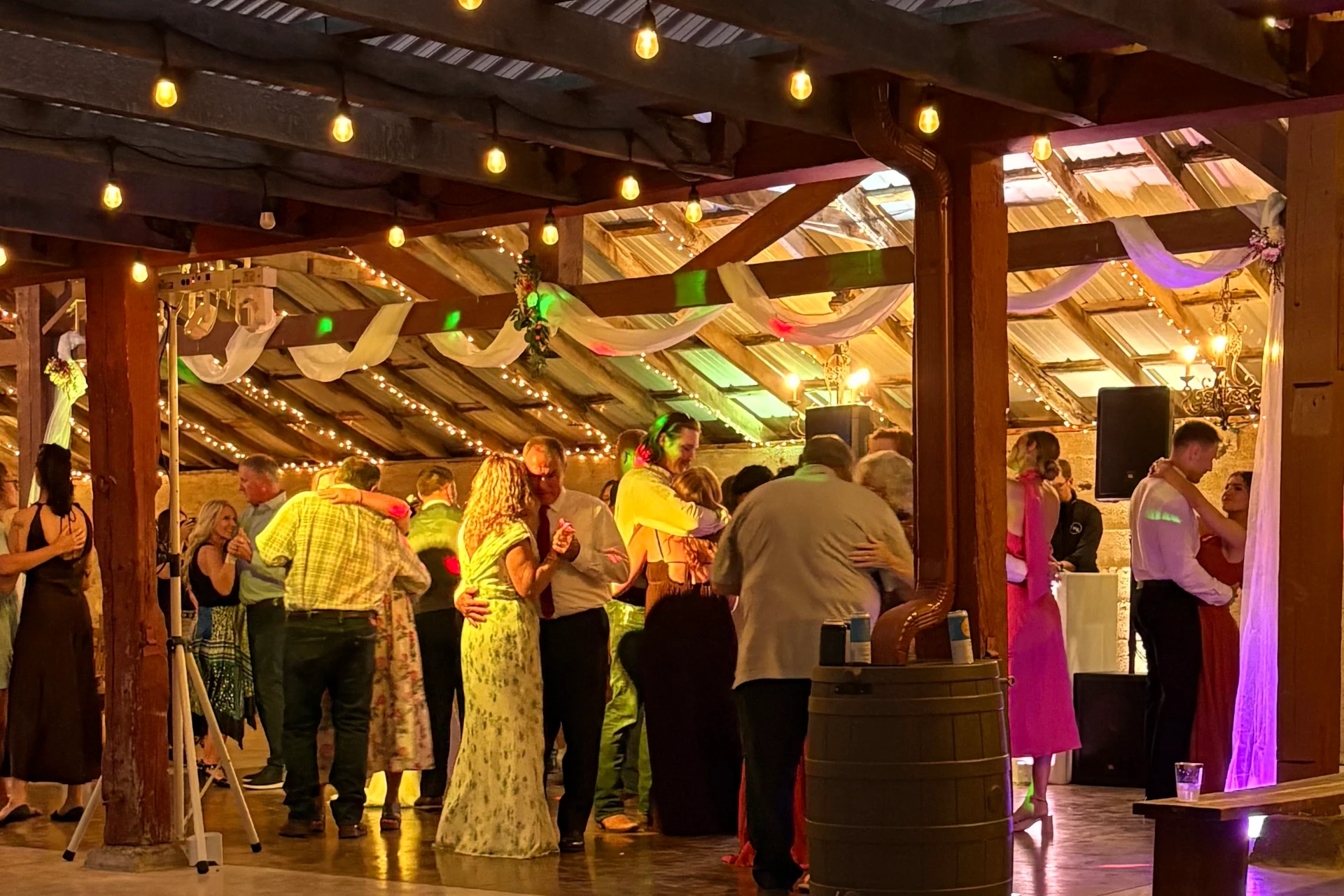 Wedding guests dance in pole barn at Civil War Ranch