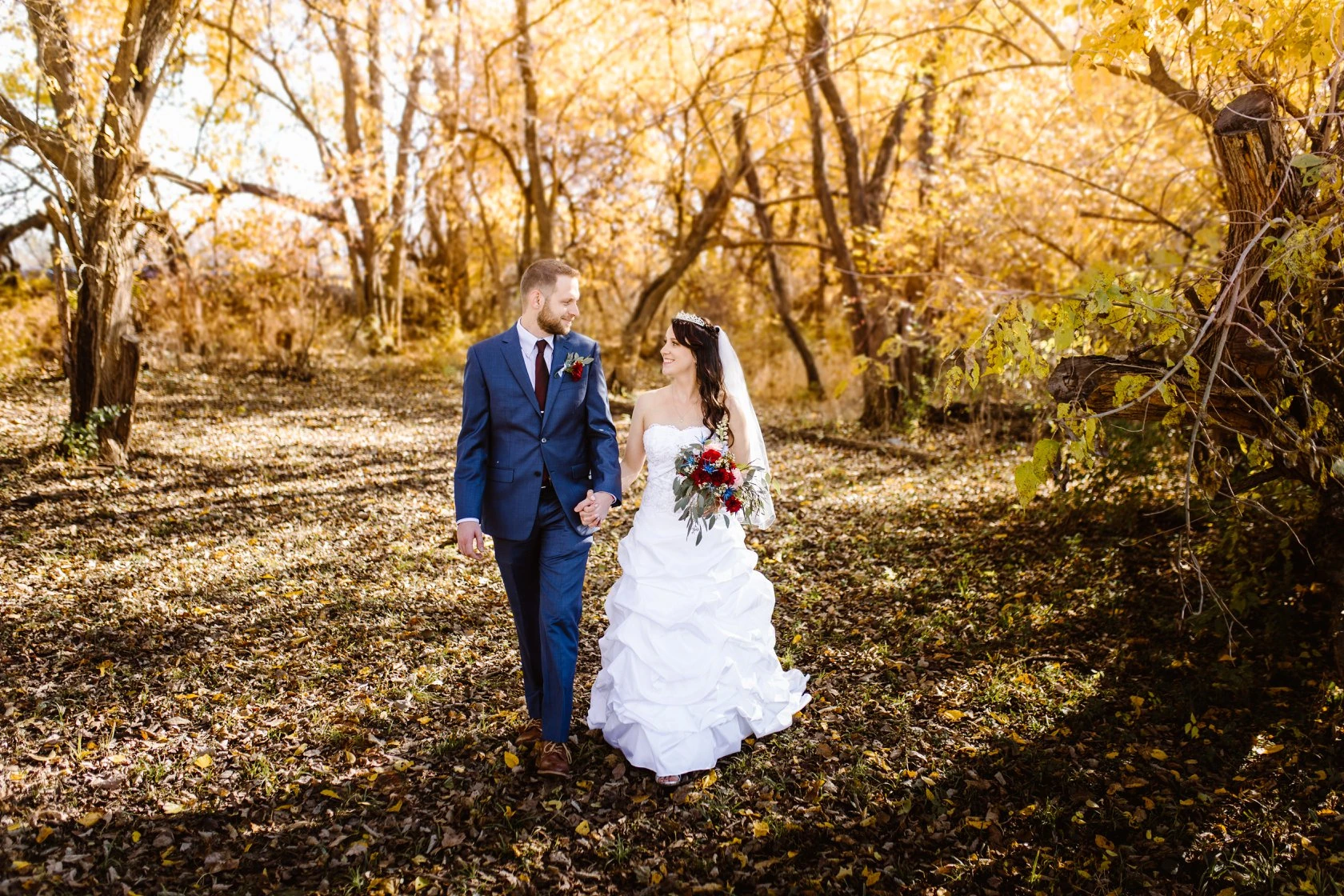 Wedding couple walks through wooded grove at Civil War Ranch